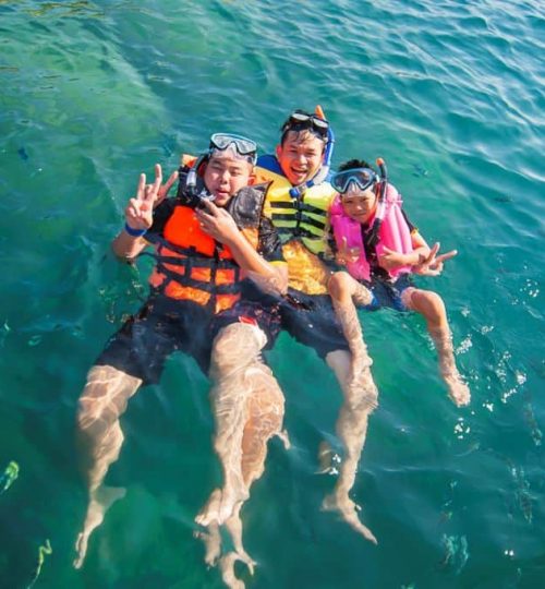 Three guys floating happily in the sea water